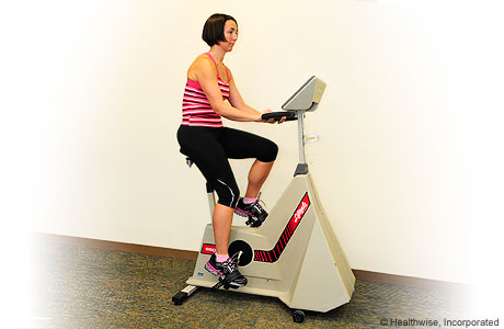 A person exercising on a stationary bike.