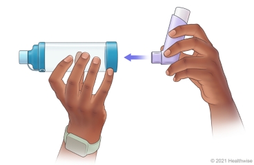 Person attaching metered-dose inhaler to end of spacer.