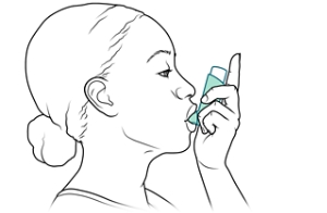 Person with lips closed around inhaler's mouthpiece.