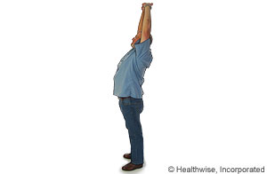 Picture of a standing overhead stretch to ease back fatigue