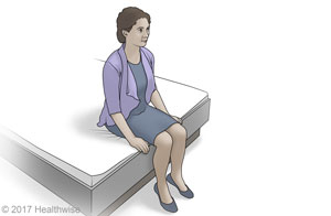 Woman sitting on the edge of a bed