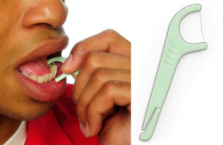 Person using a flossing tool to floss, moving floss up and down between two teeth.