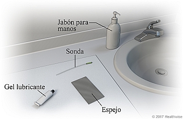 Área del lavabo del baño donde se muestran suministros de jabón para manos, sonda, gel lubricante y espejo.