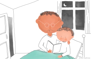 Brannon y su papá leen un libro en cama Brannon y su papá leen un libro en cama