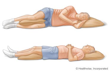 Picture of a man lying down and using pillows to help with low back pain