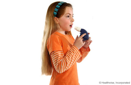 A child taking a deep breath to get ready to use the peak flow meter